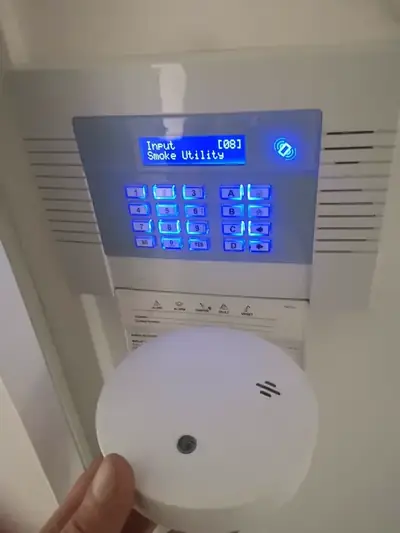Smoke alarm linked intruder alarm